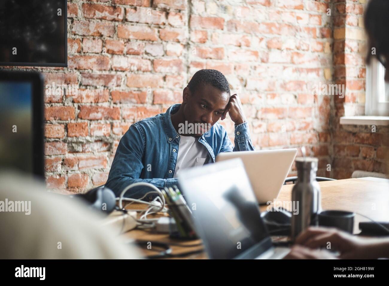 Businessman using laptop while working in office Stock Photo