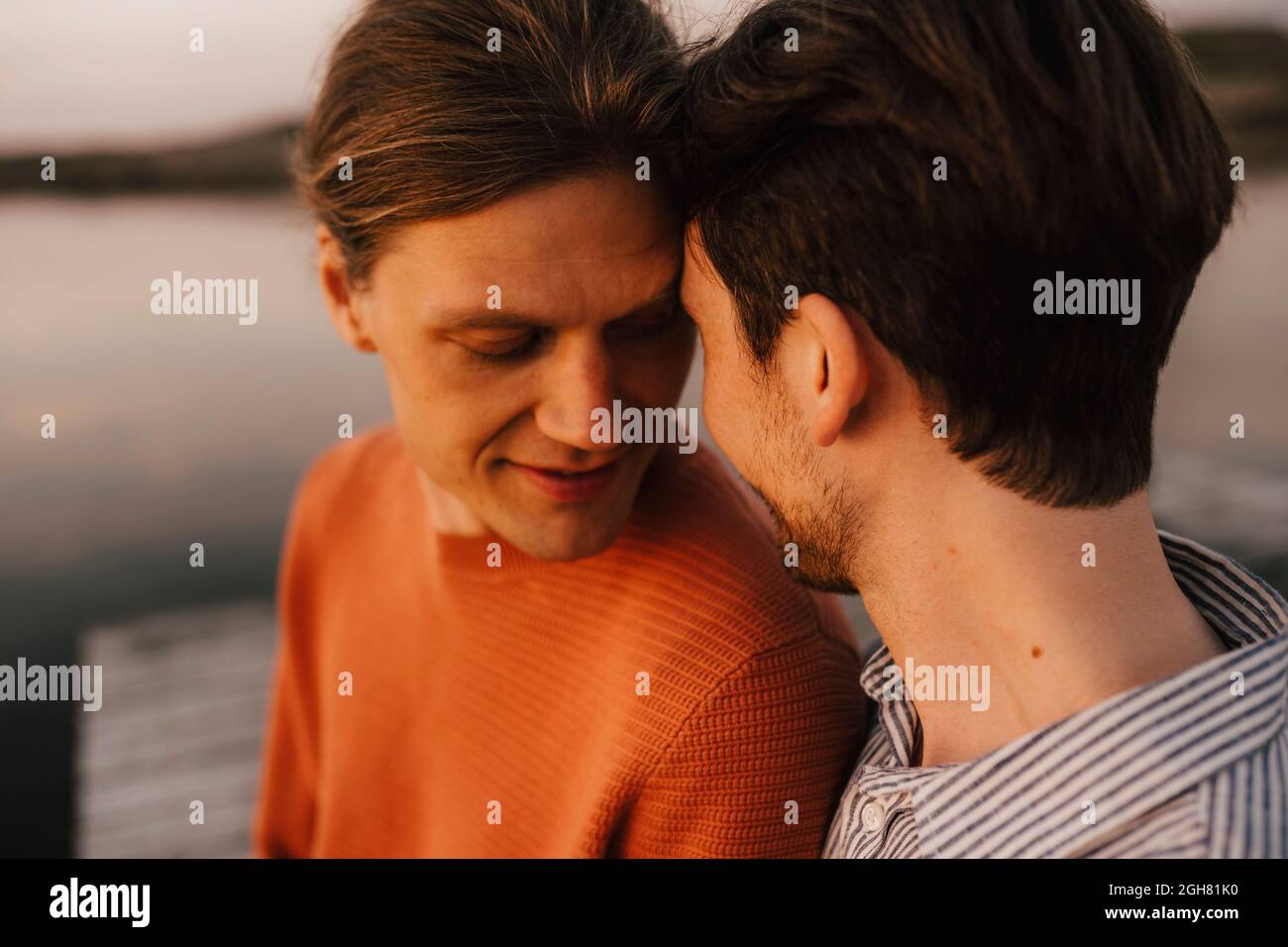 Gay couple doing romance at lakeshore Stock Photo
