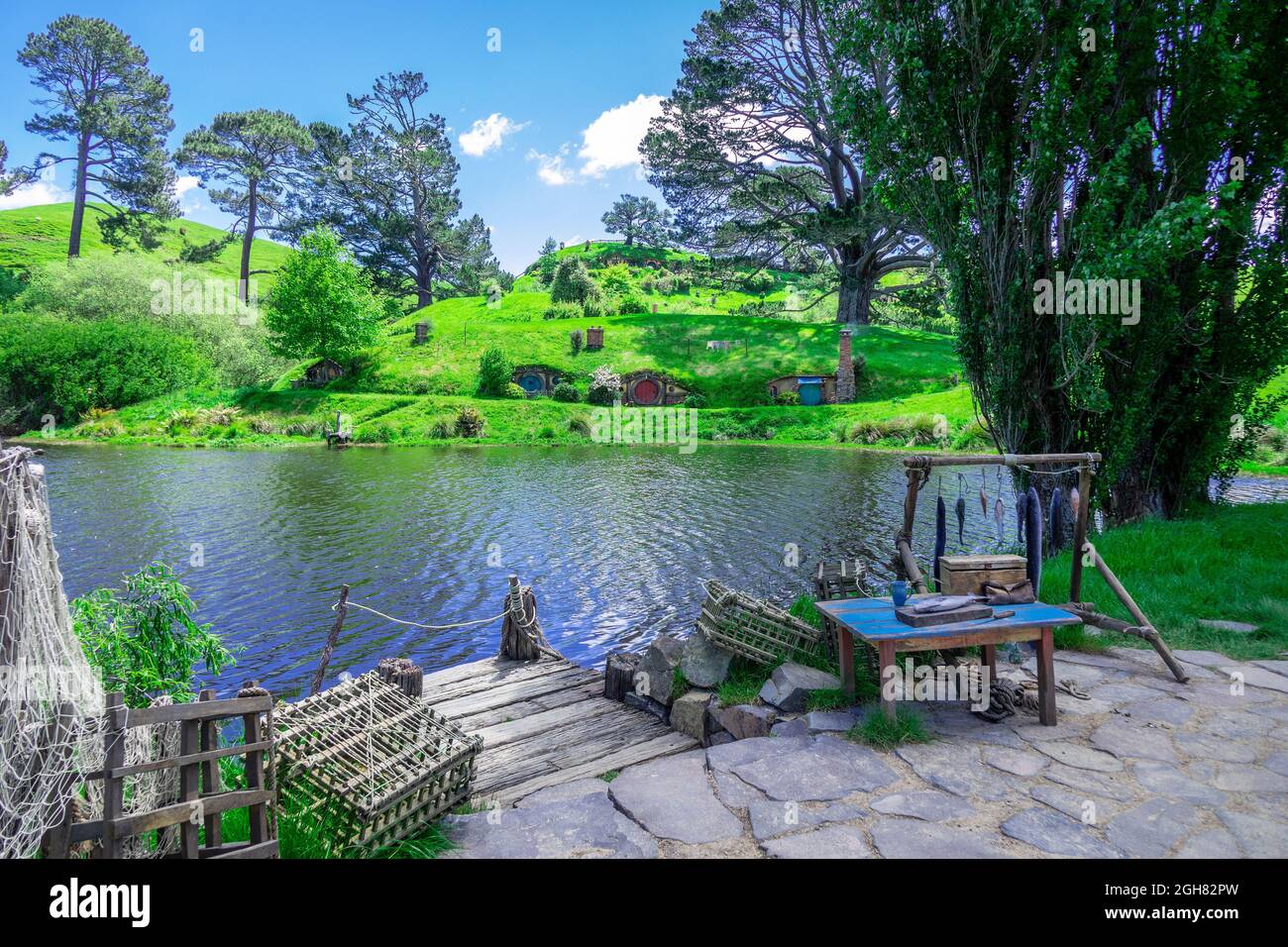 Hobbit on Movie Set In Matamata New Zealand, Hobbit Holes On The Hillside Overlooking The Lake In The Shire. Lord of The Rings. Stock Photo