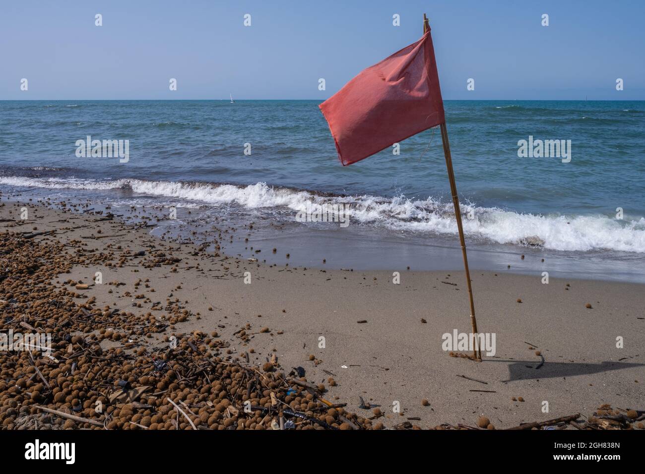 Red warning flag on the beach Stock Photo