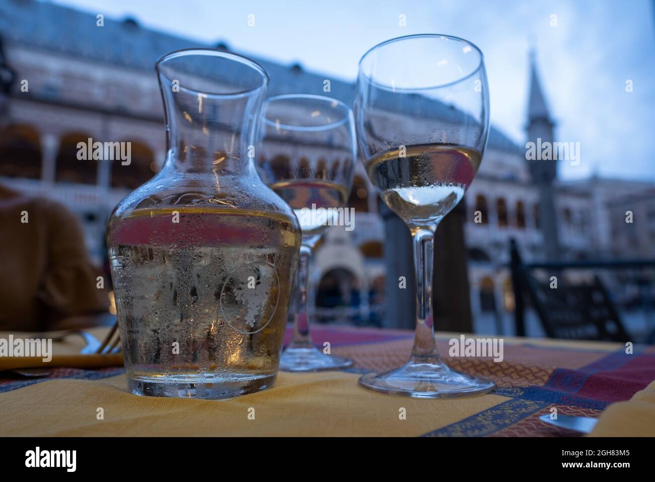 Hot summer in the city, moment of respite, glasses and carafe of white wine Stock Photo