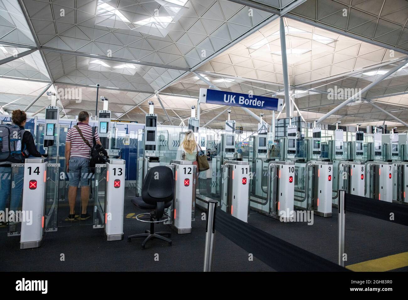 Passengers arriving from Italy at the UK Border entrance at Stansted airport.Italy is on the Amber list. Passengers must supply a test result and PLF. Stock Photo