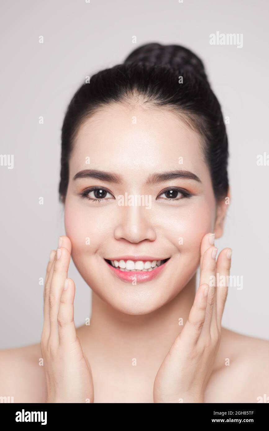 Happy smiling beautiful asian woman touching her face Stock Photo - Alamy