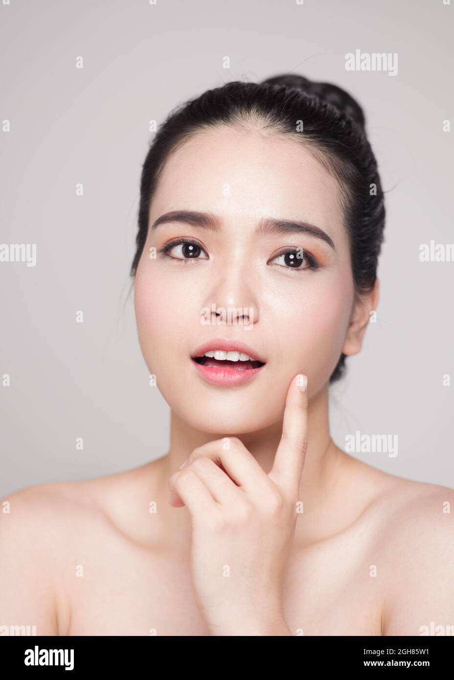 Happy smiling beautiful asian woman touching her face Stock Photo - Alamy