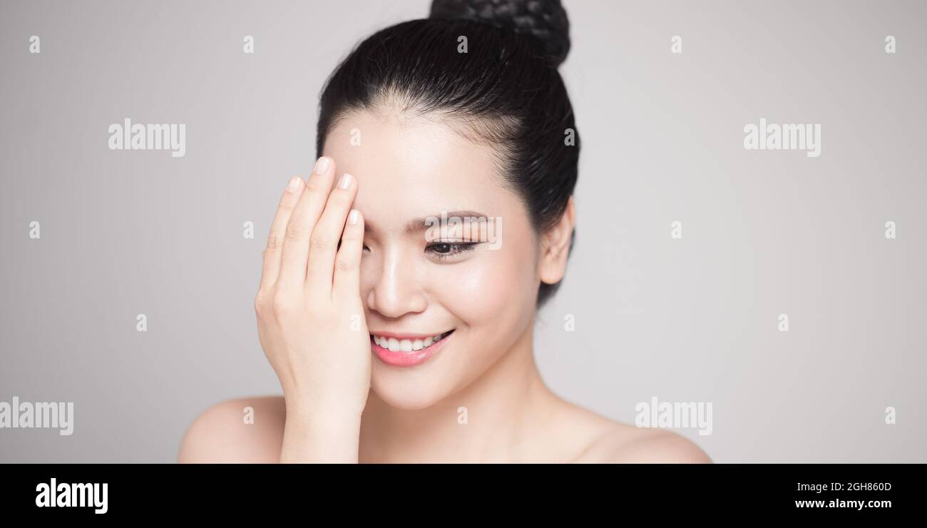 Happy smiling beautiful asian woman touching her face Stock Photo - Alamy