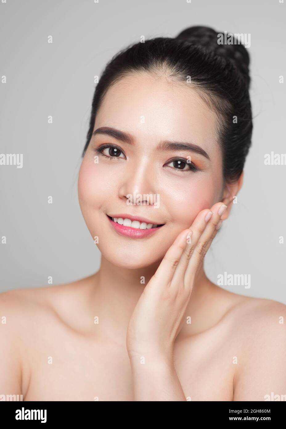Happy smiling beautiful asian woman touching her face Stock Photo - Alamy