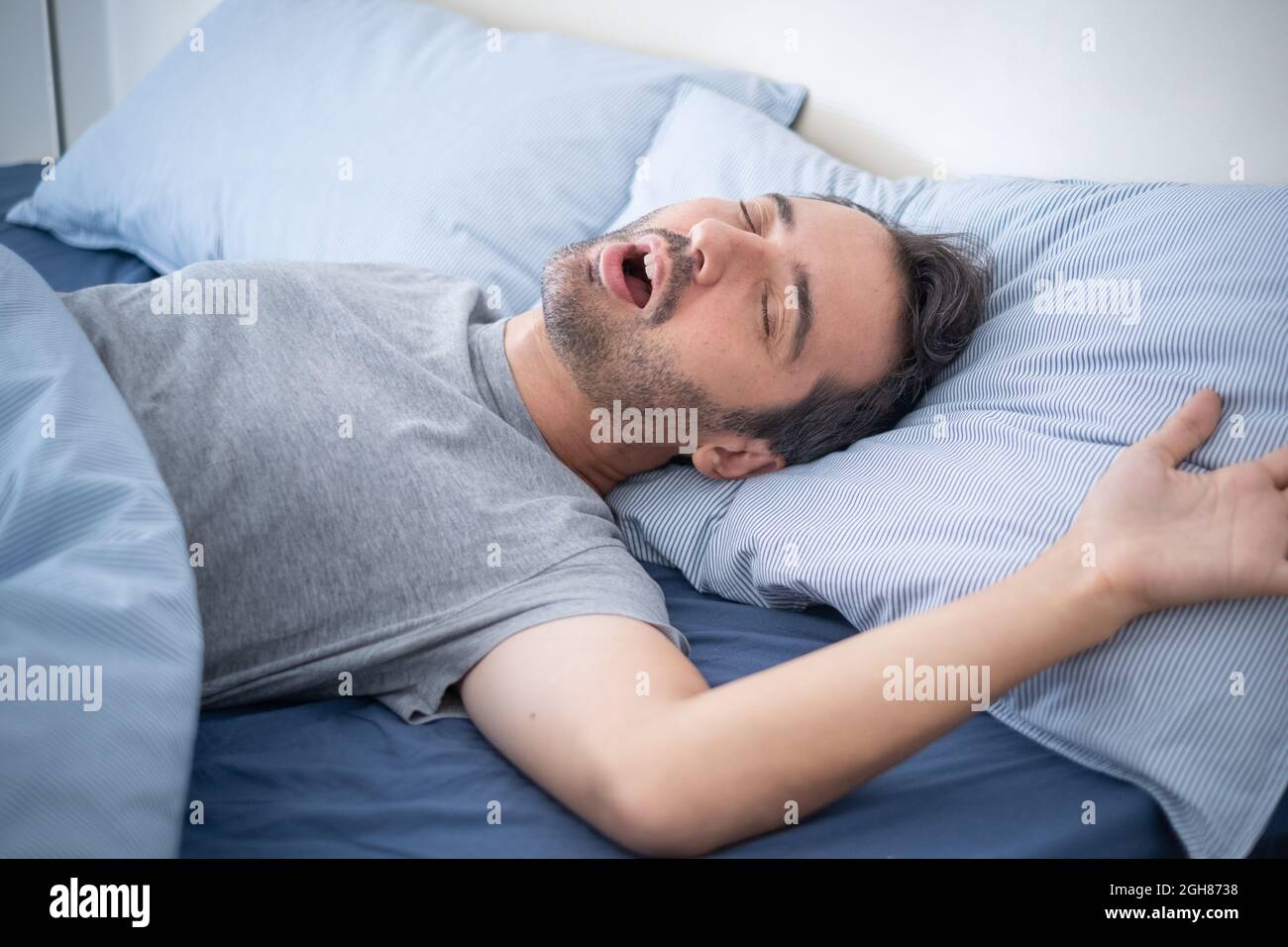 One man falling asleep and snoring in bed Stock Photo Alamy