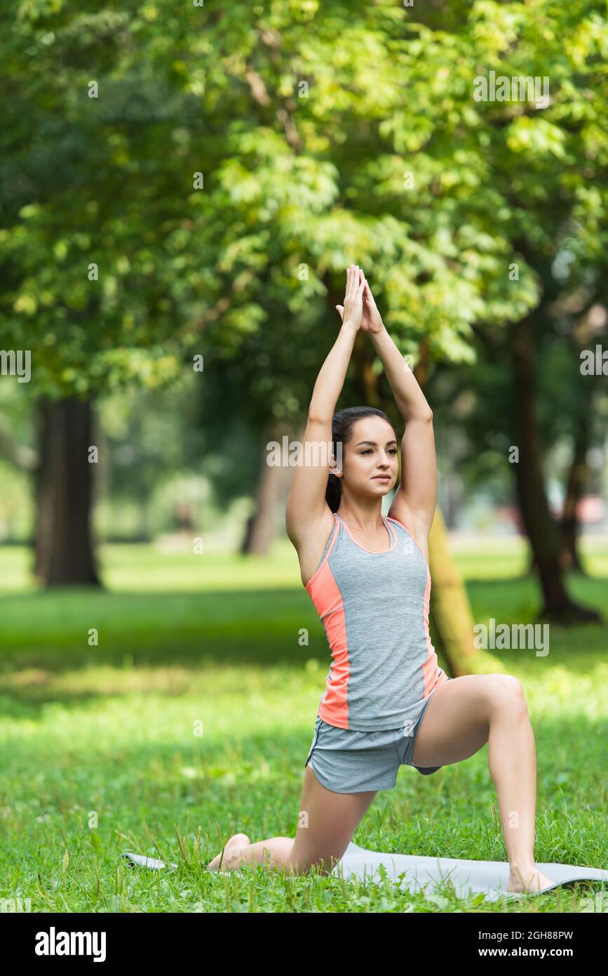 Yoga teacher doing Horizon Lunge pose in park - a Royalty Free Stock Photo  from Photocase