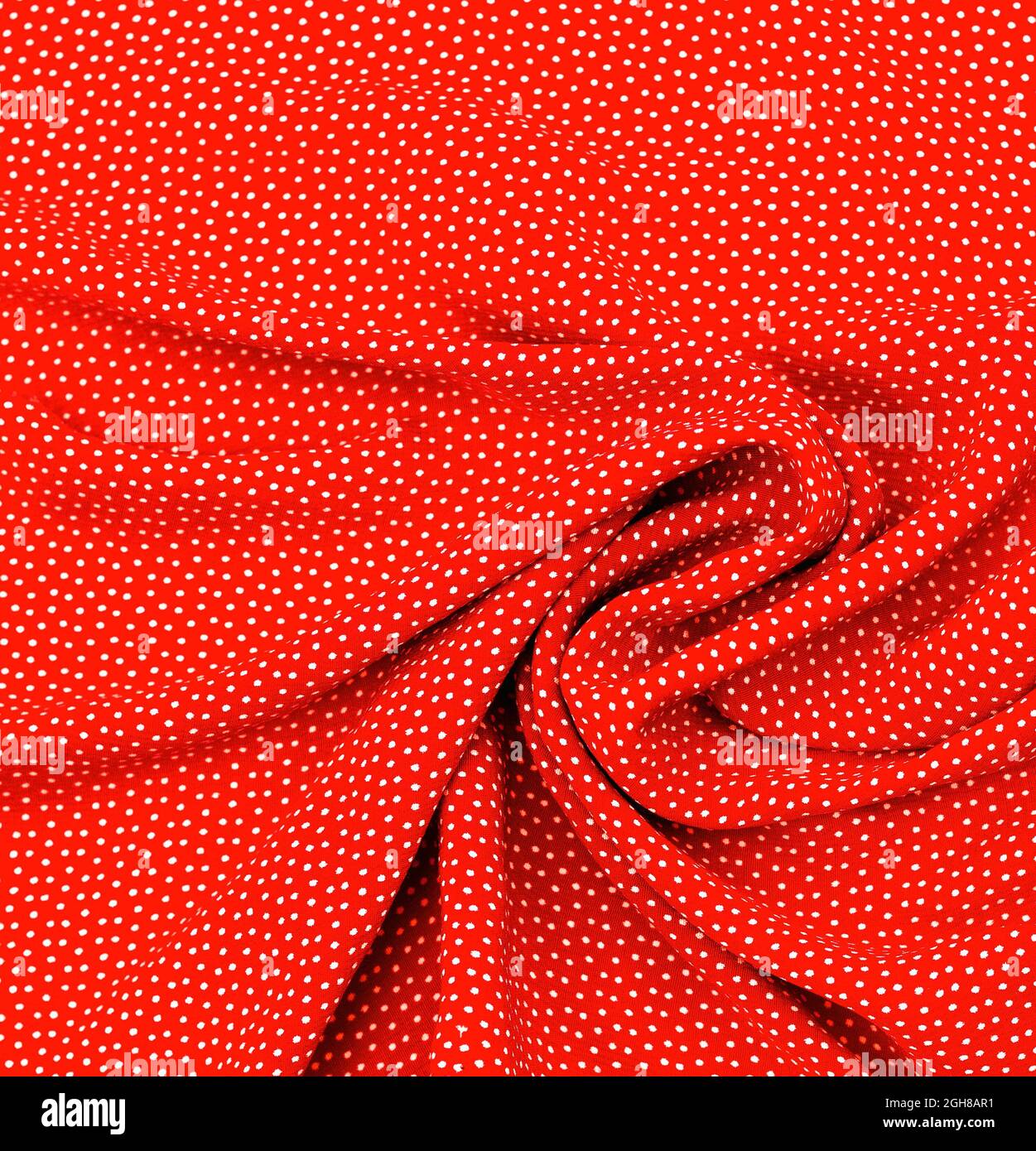 Silk fabric. white peas on red. Texture, background, pattern. Stock Photo