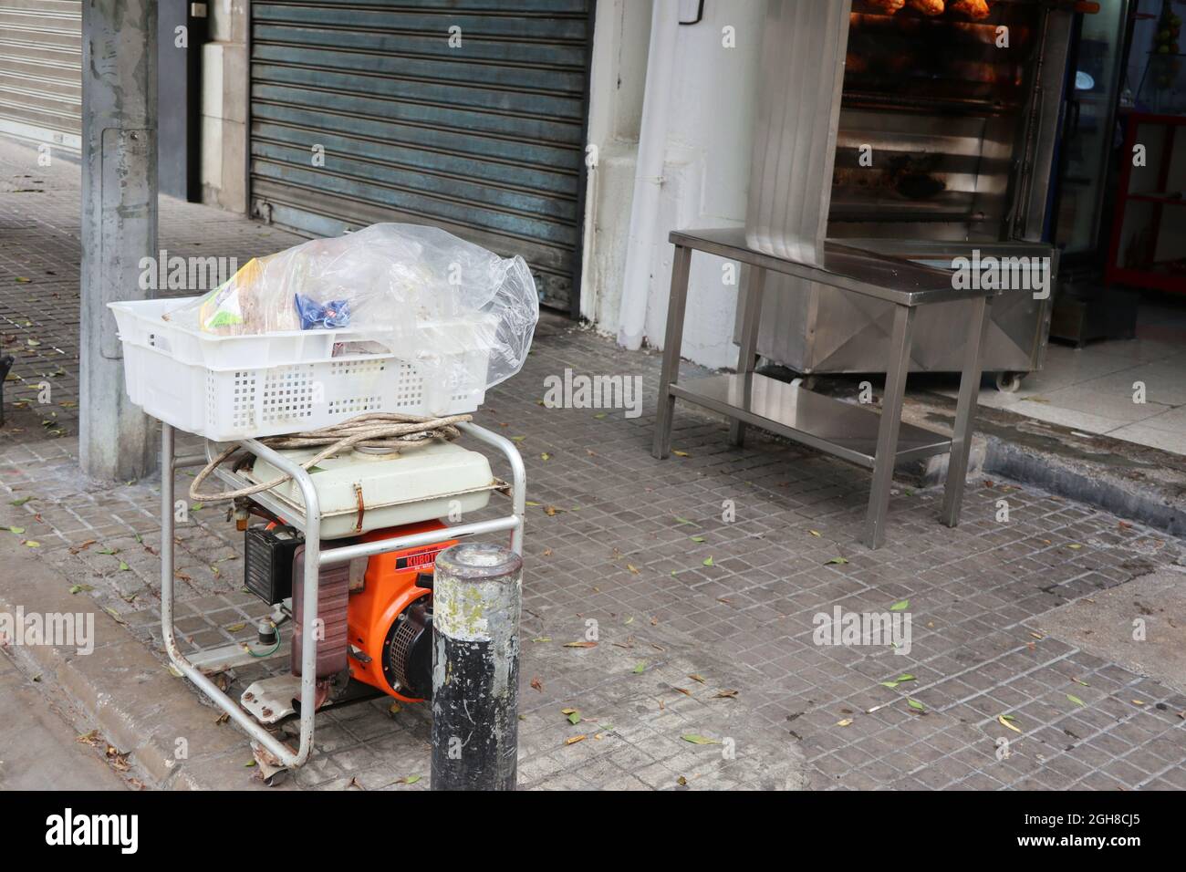 An electricity generator serves a shop in Beirut, Lebanon, September 5, 2021. In the midst of a momentous economic, financial and social crisis, Lebanon is also facing ecological crisis. Due to lack of electricity all around the Country, people are forced to use generators in a large amount for any daily need. Leaks of fuel from generators are provoking an environmental issue. (Elisa Gestri/Sipa USA) Stock Photo