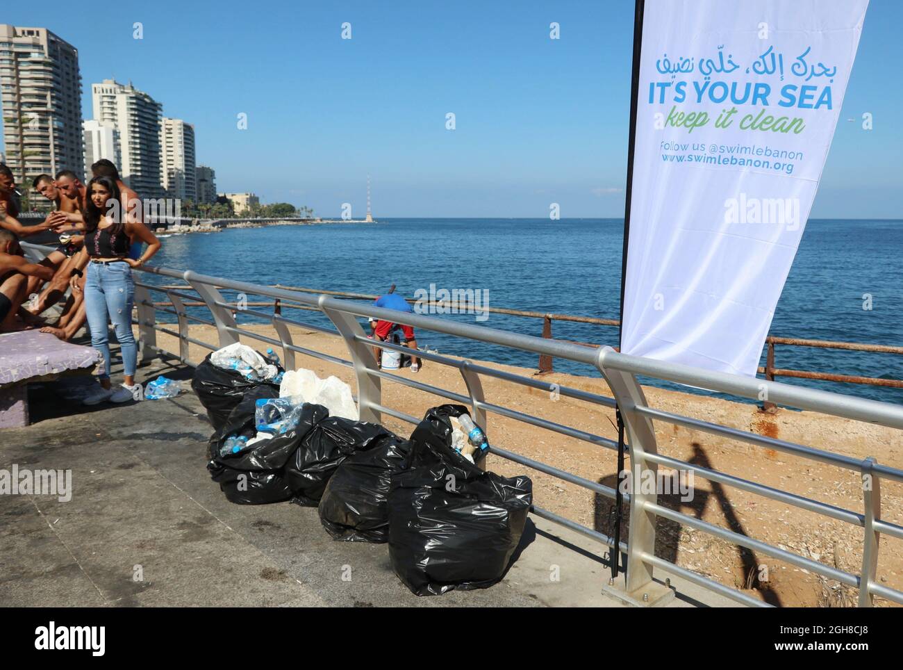 Volunteers pick up garbage in Beirut, Lebanon, September 5, 2021, according the slogan 'It's your sea, keep it safe'. In the midst of a momentous economic, financial and social crisis, Lebanon is risking an ecological meltdown too. Due to lack of fuel, in many areas of the Country waste collection has been halted. Sea and shores in Beirut and its surrounding are heavily polluted. (Elisa Gestri/Sipa USA) Stock Photo