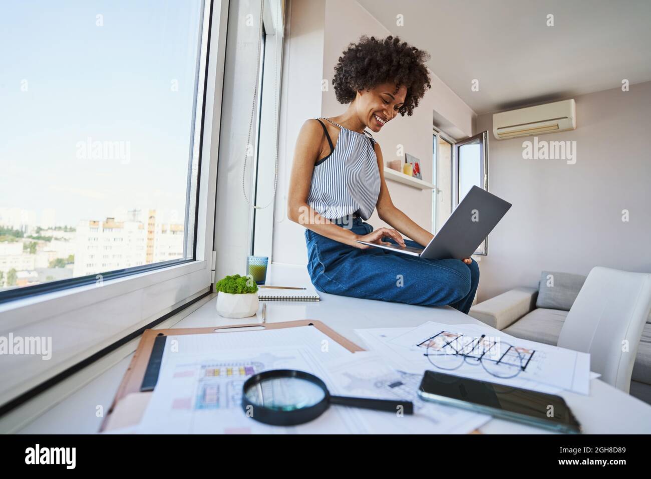 Joyous draftswoman working on the portable computer Stock Photo