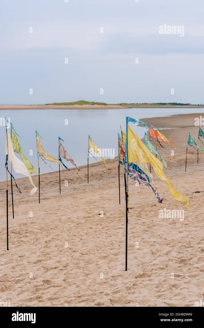 Nairn East Beach, Highlands, Scotland, UK. 5th September, 2021. As part of the Nairn Books and Arts Festival there was a Kinetika Flag Installation. ' A stunning installation of 500 naturally dyed silk flags on Nairn’s East Beach by international outdoor arts company Kinetika. Created by communities along the East coast of the UK as part of the Beach of Dreams project, the flags will be enhanced by flags inspired by Nairn Beach created by members of the local community at workshops led by Ali Pretty, Artistic Director of Kinetika. ' CREDIT - JASPERIMAGE/AlamyLiveNews Stock Photo
