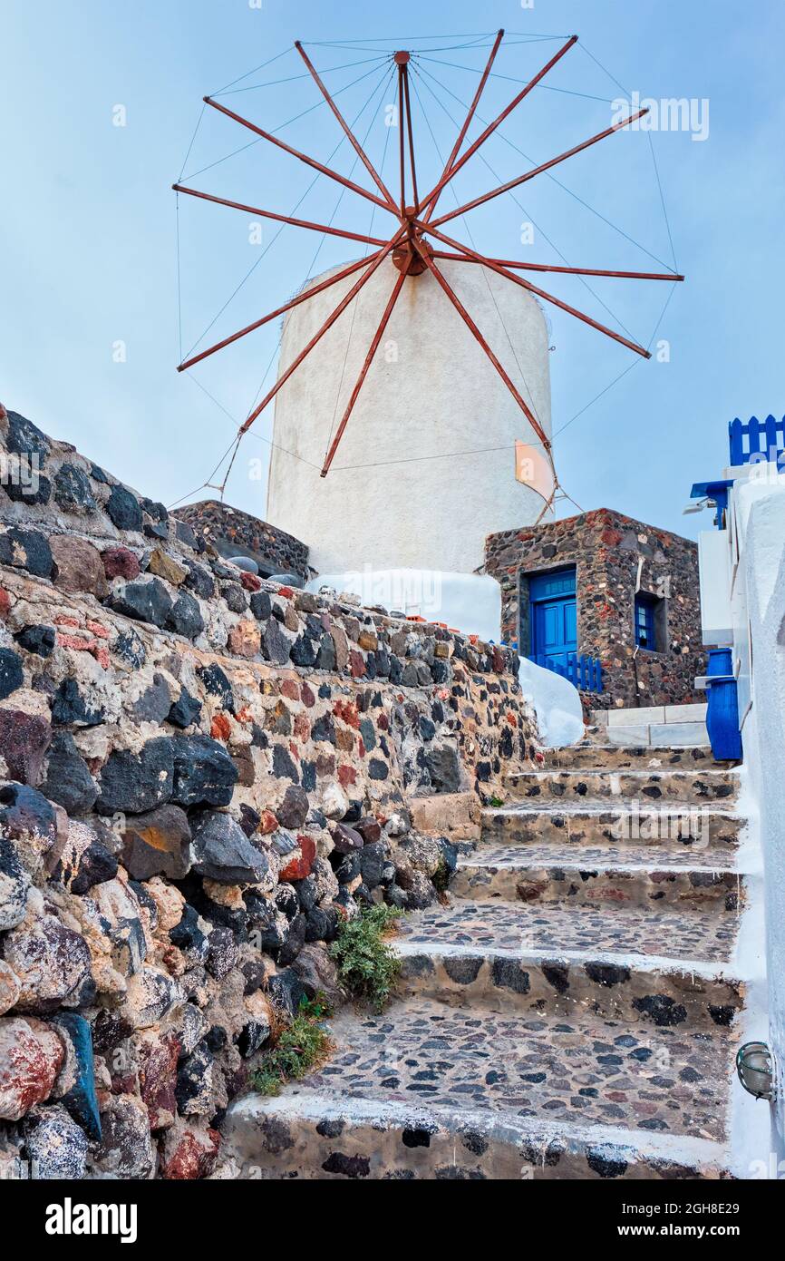 Old greek windmill on Santorini island in Oia town with stairs in street. Santorini, Greece Stock Photo