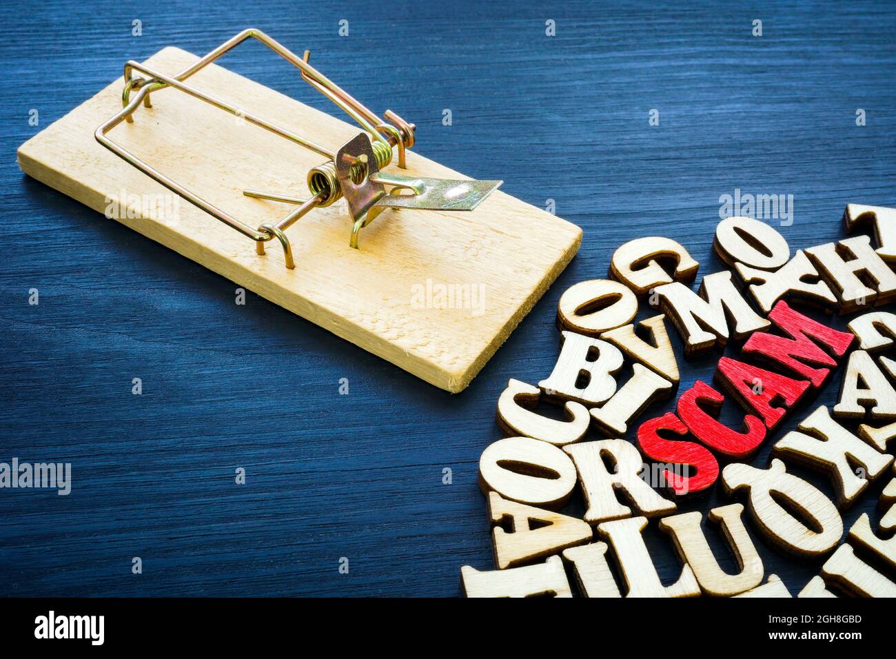 Word scam from red letters and mousetrap. Stock Photo