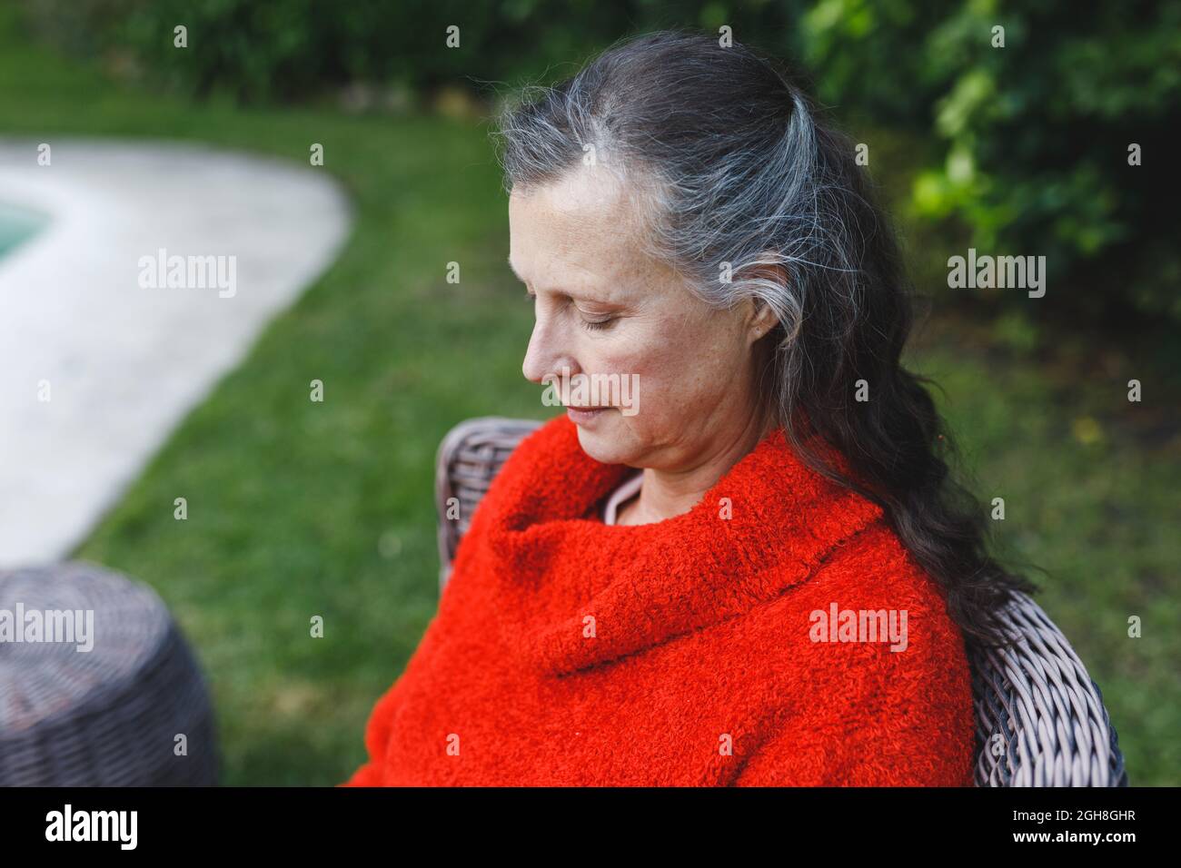 Happy senior caucasian woman sitting on chair in garden Stock Photo - Alamy