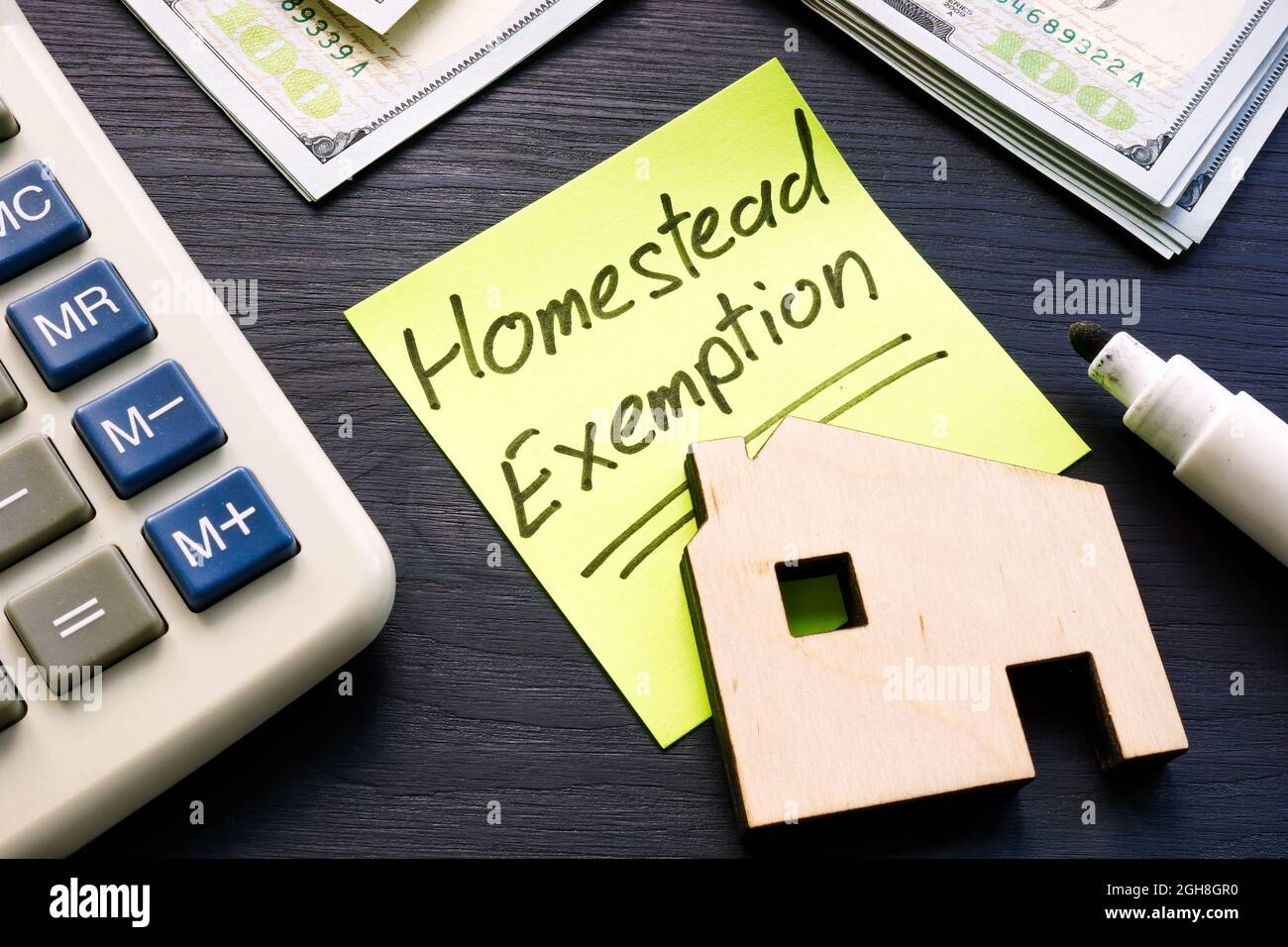 Homestead exemption written on the sticker and model of home. Stock Photo