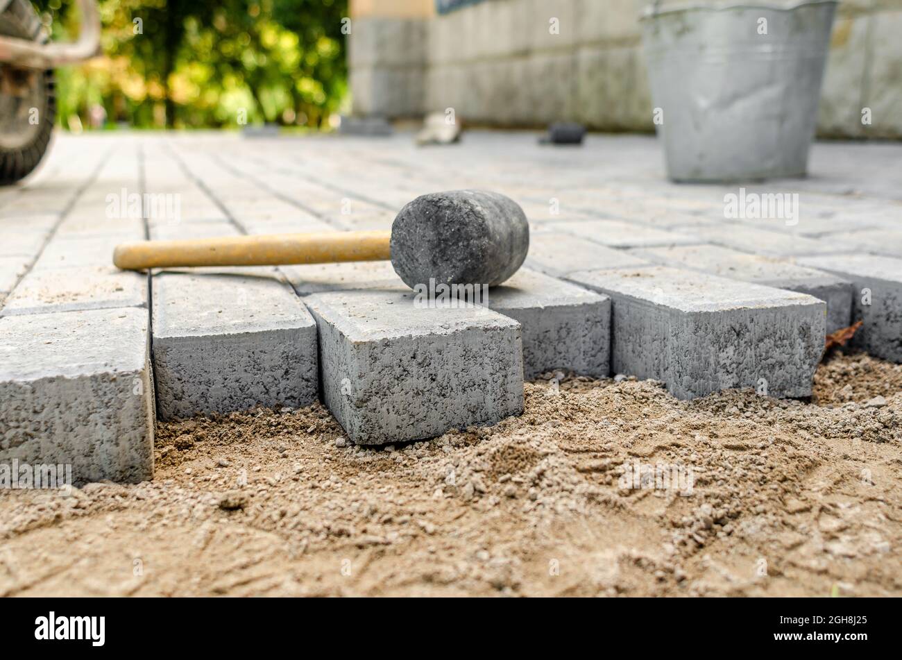 Hammer for sealing the pavement on the newly laid pavement. process of