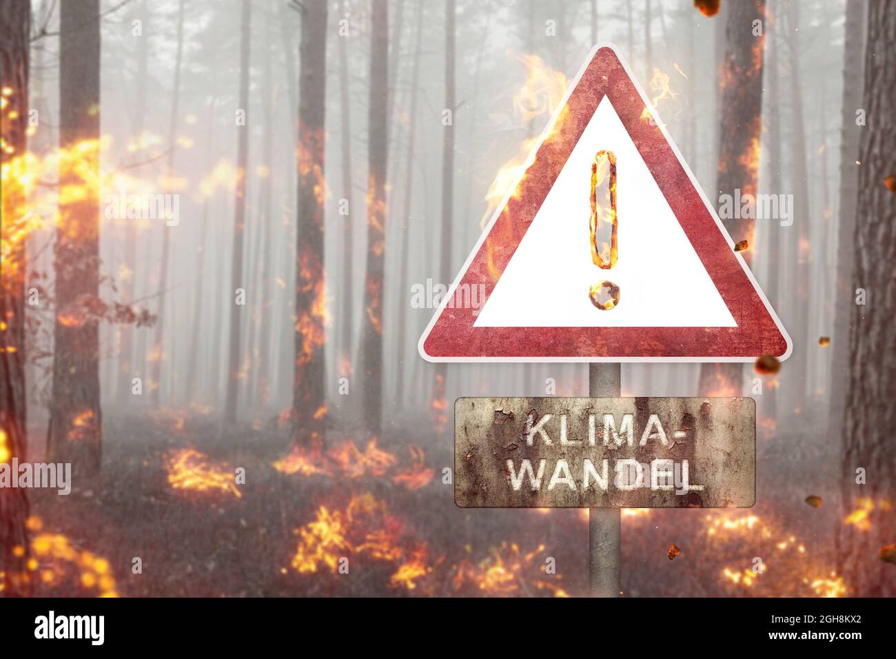 Climate Change warning sign in a burning forest Stock Photo
