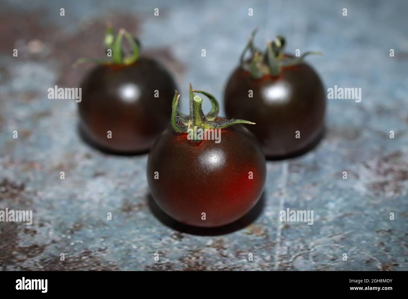 Black tomatoes in the table Stock Photo