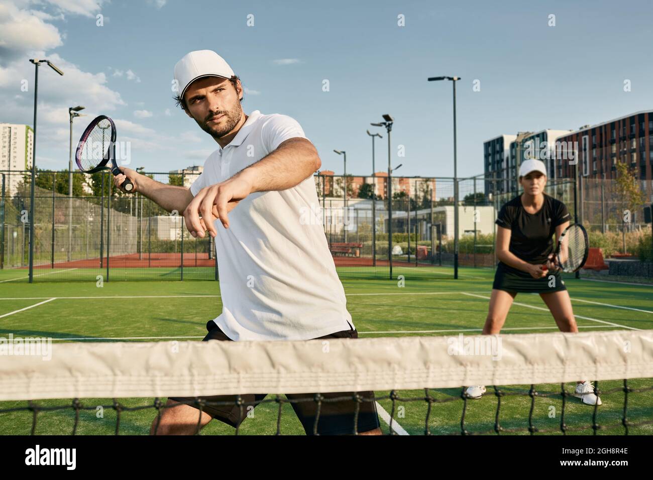 Doubles team of tennis players while playing tennis match. tennis teamwork Stock Photo