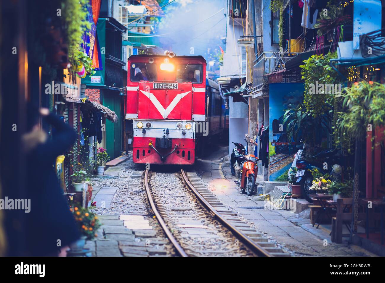Train running in the old town in Hanoi - Vietnam Stock Photo