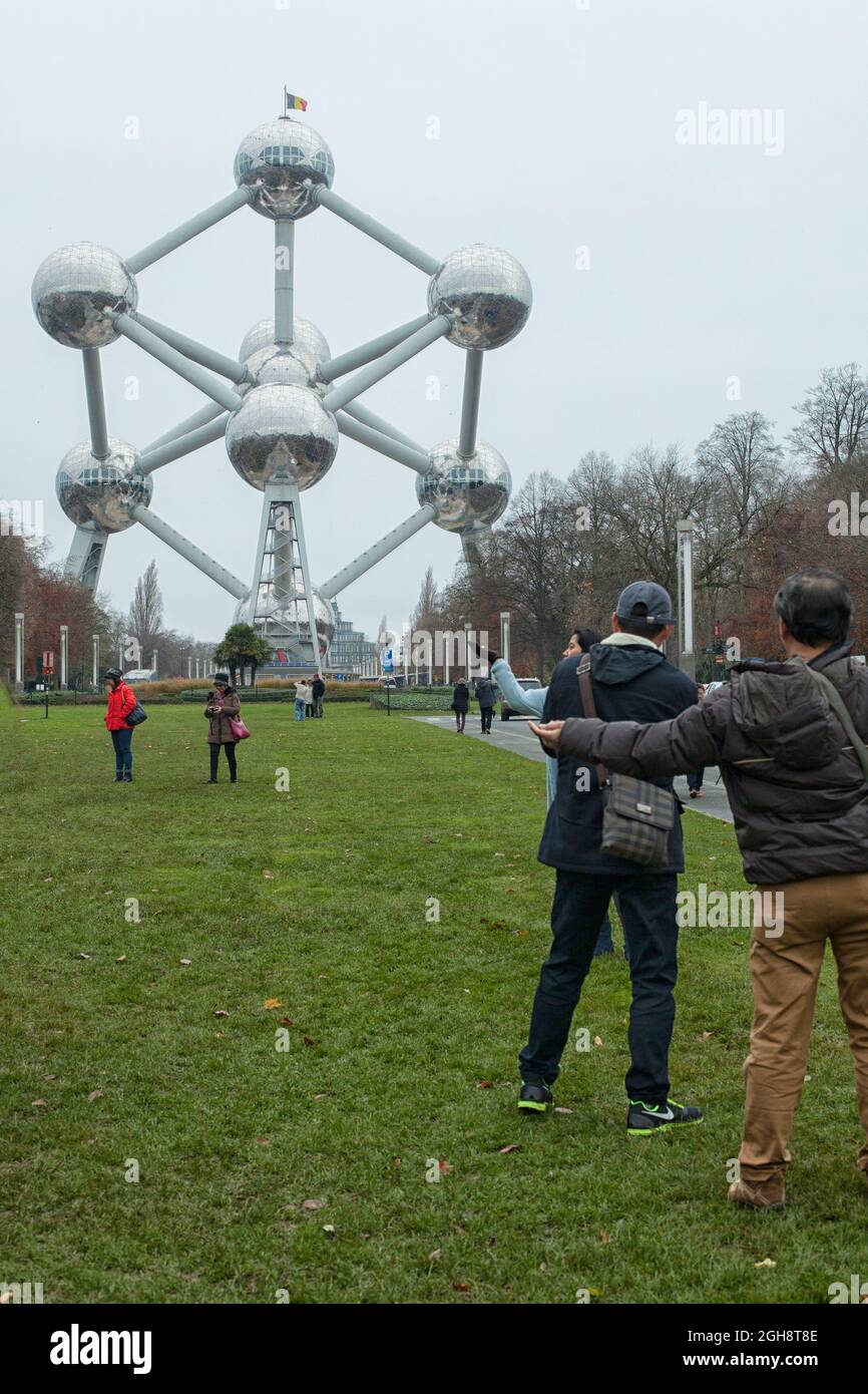 The Atomium structure in Brussels, Belgium with Asian tourists. The ...