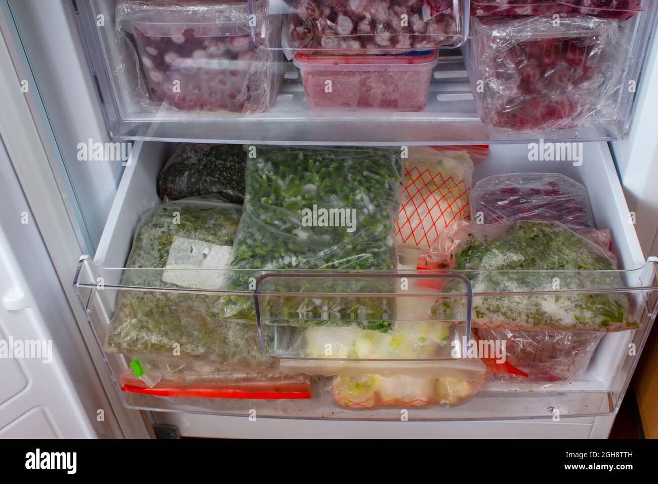 https://c8.alamy.com/comp/2GH8TTH/open-freezer-with-frozen-red-cherries-and-frozen-vegetables-food-storage-frozen-products-stocks-of-products-for-the-quarantine-period-2GH8TTH.jpg