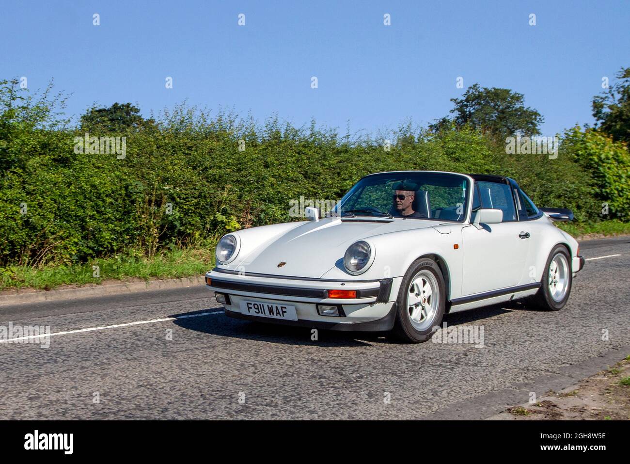 1989 80s eighties white Porsche 911 Carrera Targa Sport en-route to Capesthorne Hall classic July car show, Cheshire, UK Stock Photo