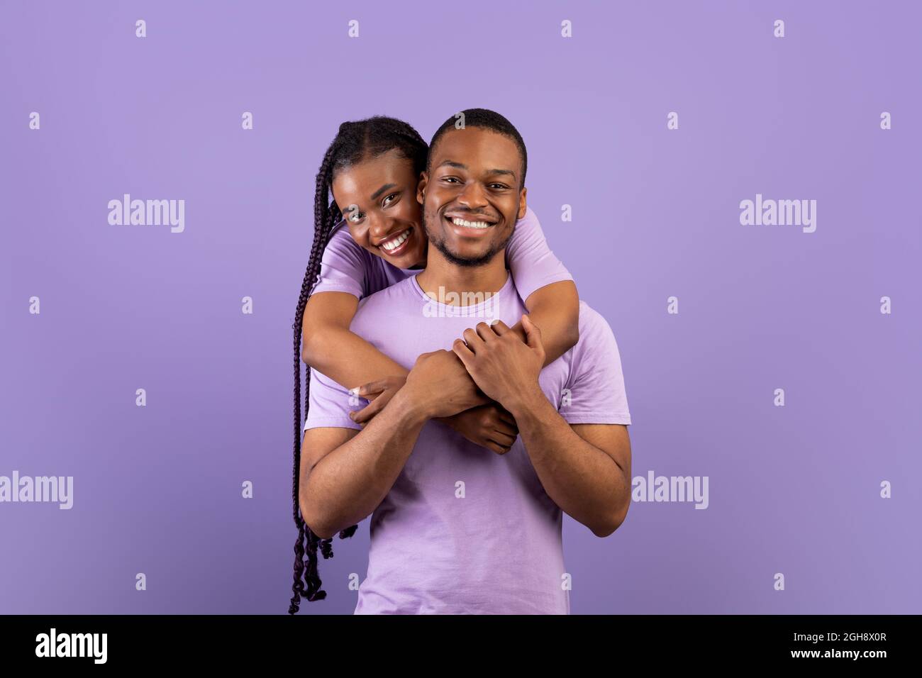 Happy african woman hugging hi-res stock photography and images - Alamy