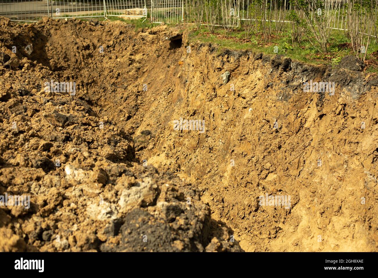 Laying pipes in the ground. The excavated soil during construction ...