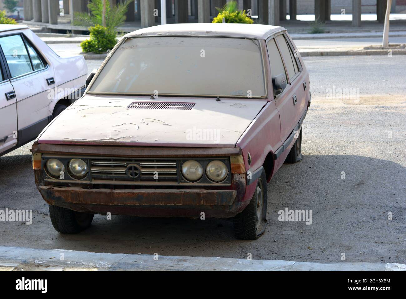 Cairo, Egypt, August 13 2021, an old retro rusty dirty car parked in the street with