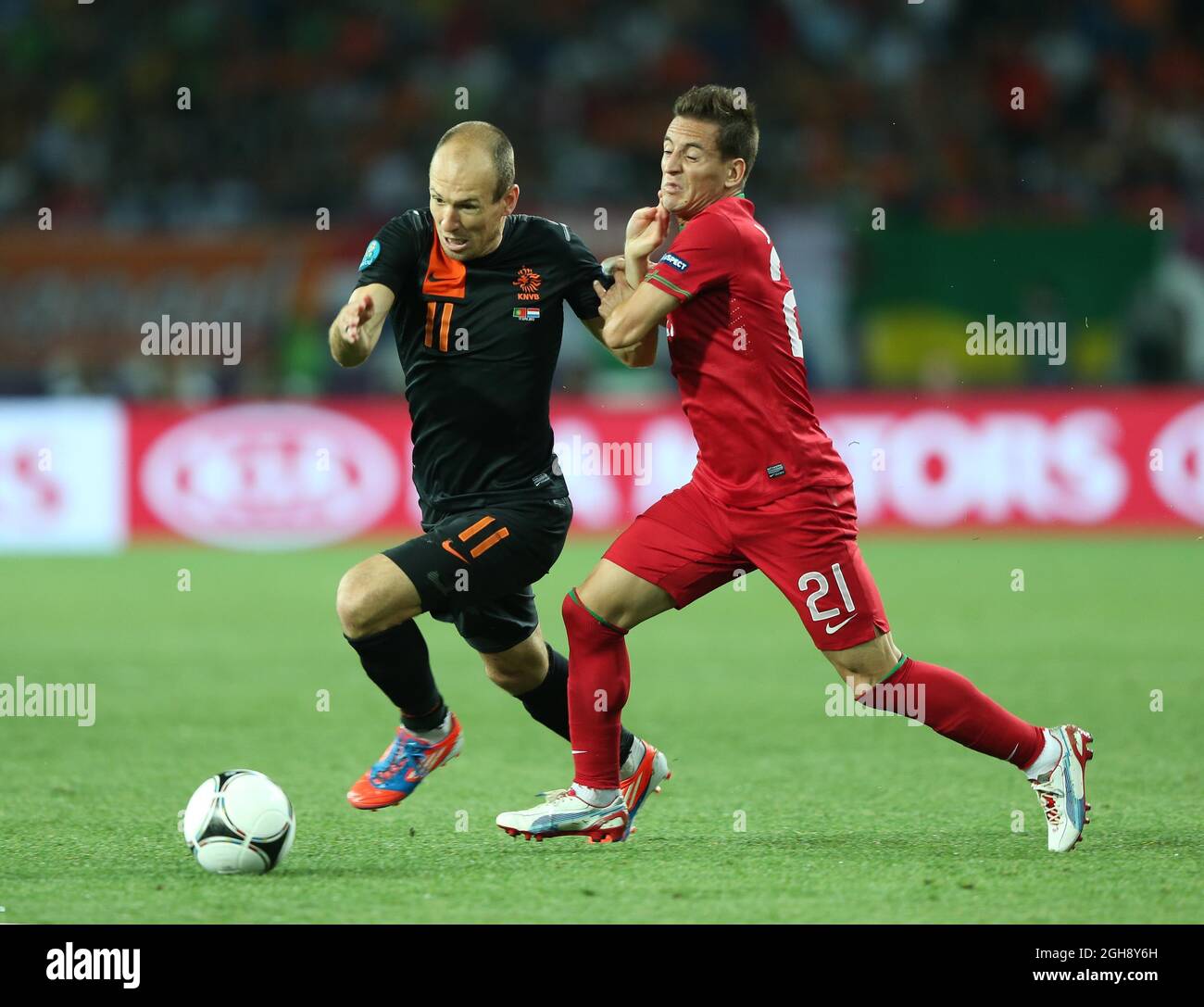 Portugals Joao Pereira tussles with Netherlands Arjen Robben during the Euro 2012 Portugal v Netherlands, Metalist Stadium, Kharkiv, 17th June 2012. Stock Photo