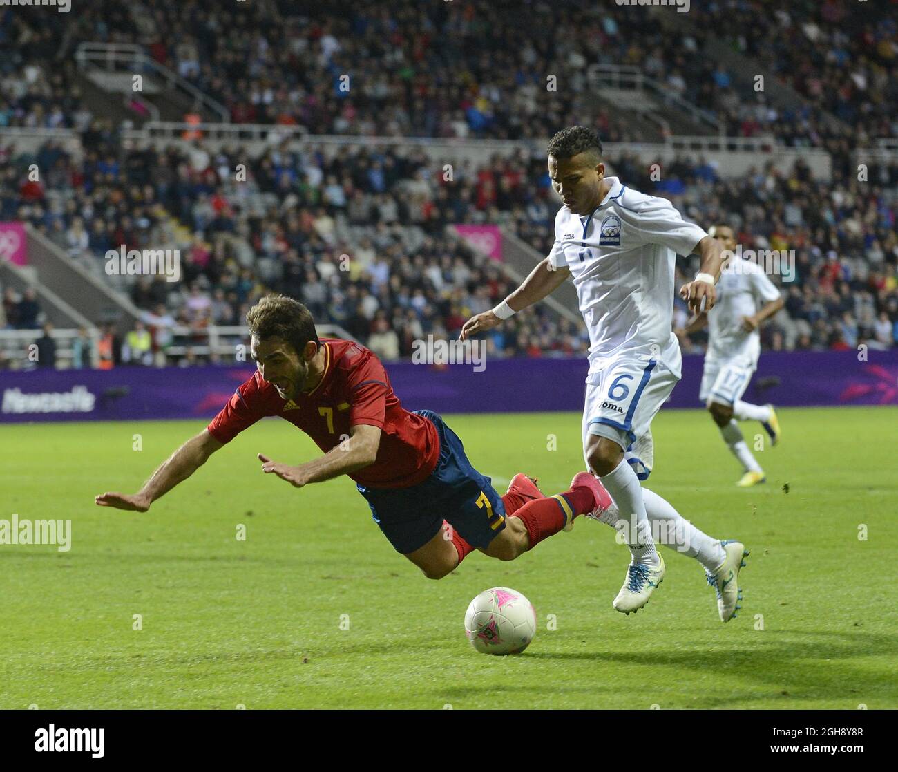 Spain's Adrian Lopez (L) is brought down by Honduras' Arnold Peralta in the penalty area but no decision is given during the London Olympic 2012 first round Group D men's match between Spain v Honduras at the St. James' Park, Newcastle upon Tyne on the 29th July 2012. Stock Photo