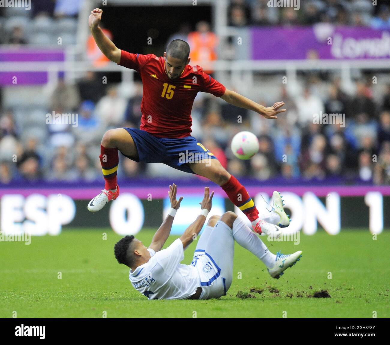 Spain's Isco avoids a challenge from Honduras' Arnold Peralta during the London Olympic 2012 first round Group D men's match between Spain v Honduras at the St. James' Park, Newcastle upon Tyne on the 29th July 2012. Stock Photo