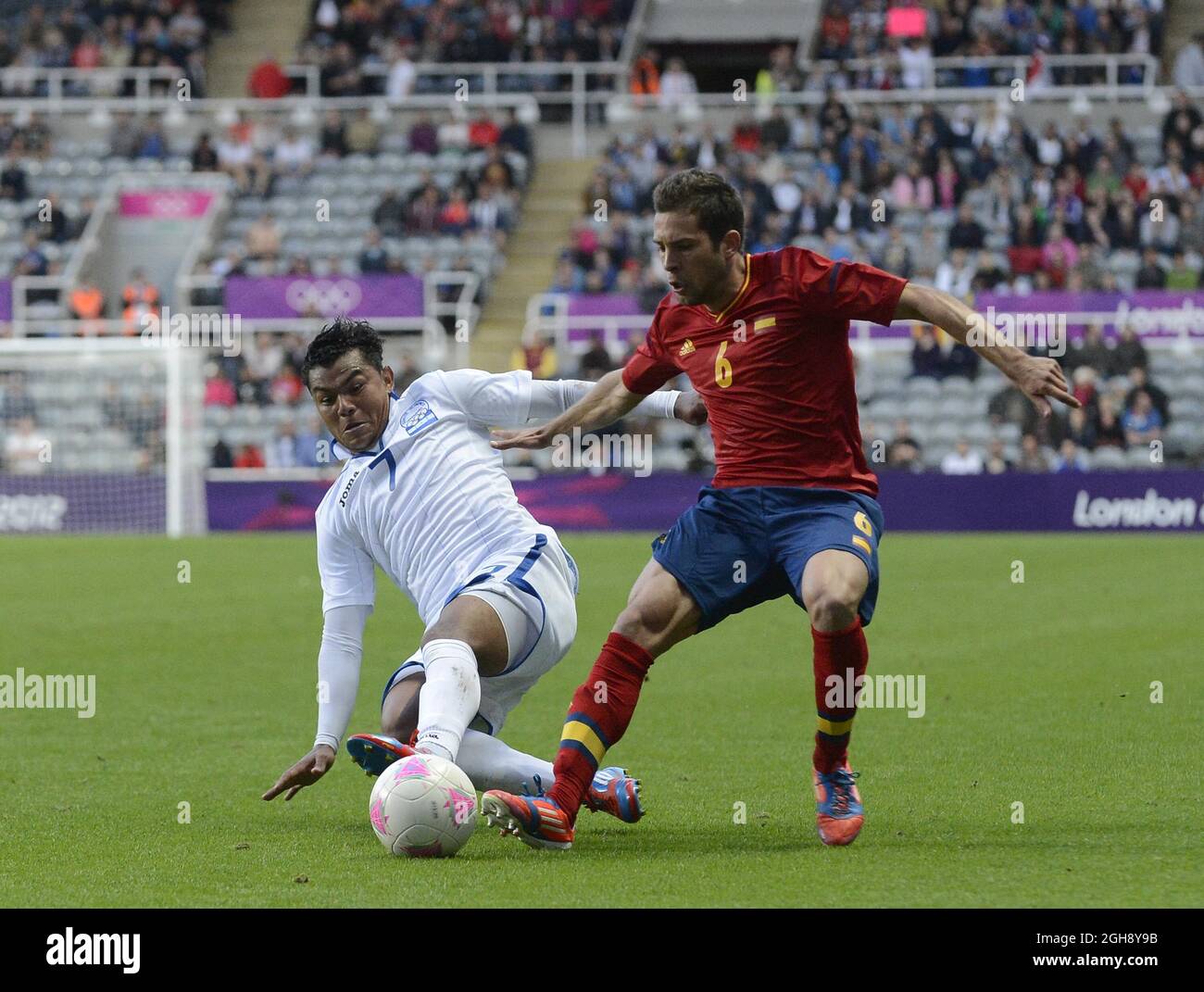 Honduras' Mario Martinez (L) Spain's Jordi Alba during the London Olympic 2012 first round Group D men's match between Spain v Honduras at the St. James' Park, Newcastle upon Tyne on the 29th July 2012. Stock Photo