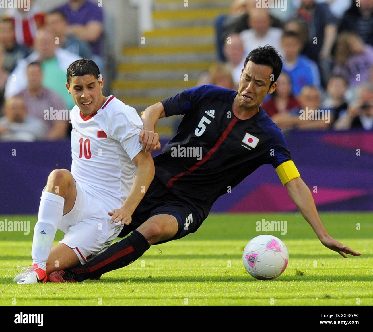 Morocco's Abdelaziz Barrada (L) and Japan's Maya Yoshida during the London Olympic 2012 Group D men's match between Japan v Morocco at the St. James' Park, Newcastle upon Tyne on the 29th July 2012. Stock Photo