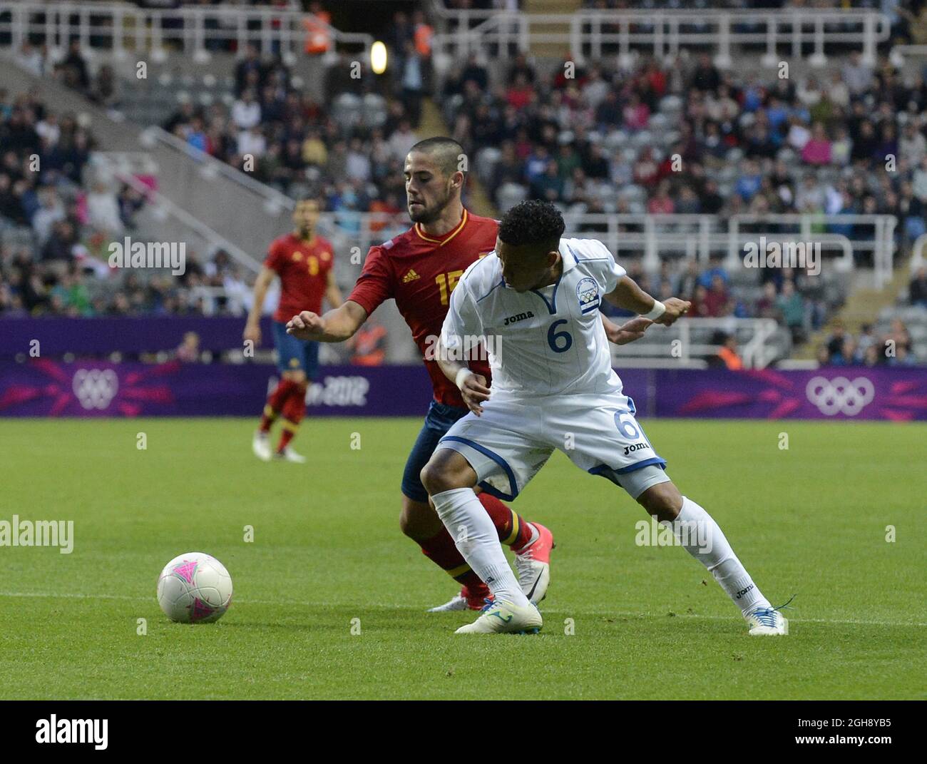 Spain's Isco (L) and Honduras' Arnold Peralta jostle for the ball during the London Olympic 2012 first round Group D men's match between Spain v Honduras at the St. James' Park, Newcastle upon Tyne on the 29th July 2012. Stock Photo