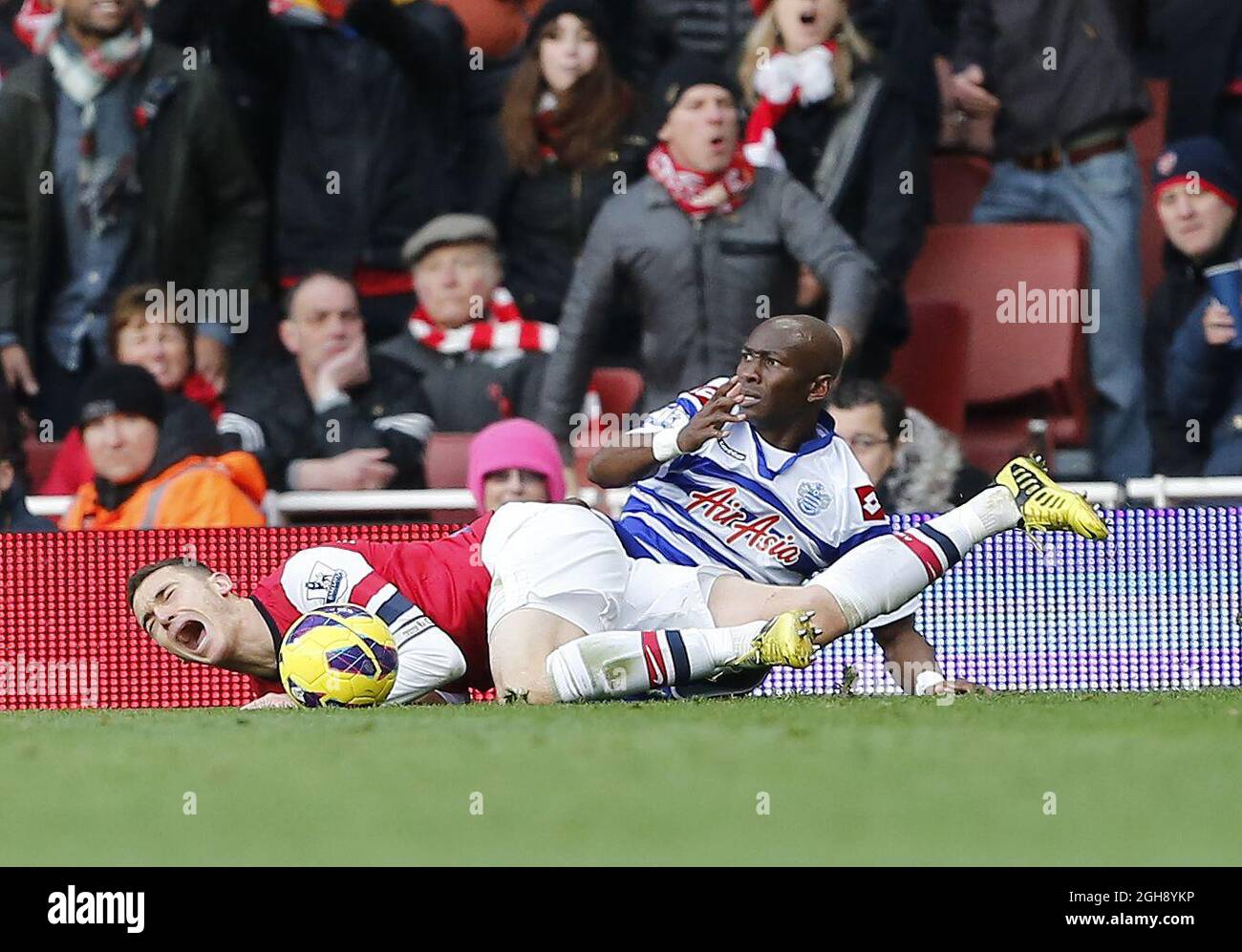 QPR's Stephane Mbia gets sent off for this tackle on Arsenal's Thomas Vermaelen during the Barclays Premier League match at the Emirates Stadium, London on October 27, 2012. Stock Photo