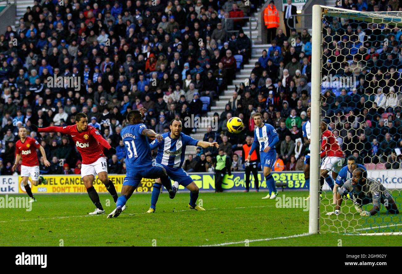 Javier Hernandez (L) of Manchester United scores their opening goal during Barclays Premier League soccer match between Wigan Athletic and Manchester United at the DW Stadium in Wigan, United Kingdom on 1st January 2013 Stock Photo