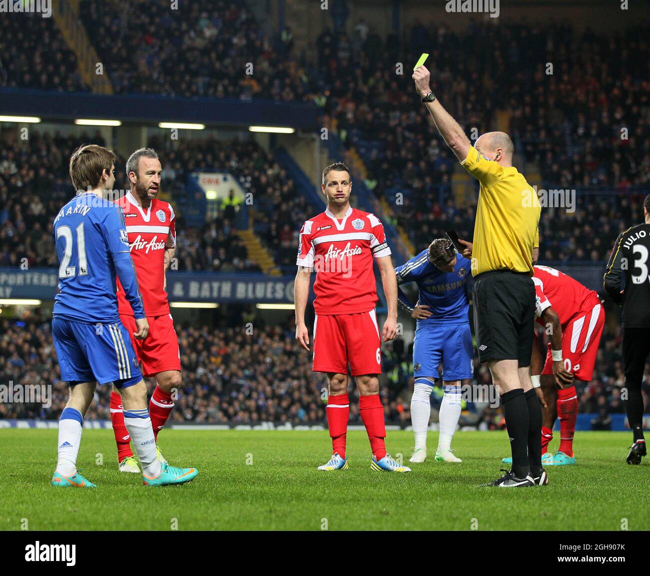 QPR's Clint Hill looks on in amazement as Chelsea's Marko Marin receives a booking for a tackle on Stephane Mbia during the Barclays Premier League match between Chelsea and QPR at Stamford Bridge on January 2, 2013 in London. Stock Photo