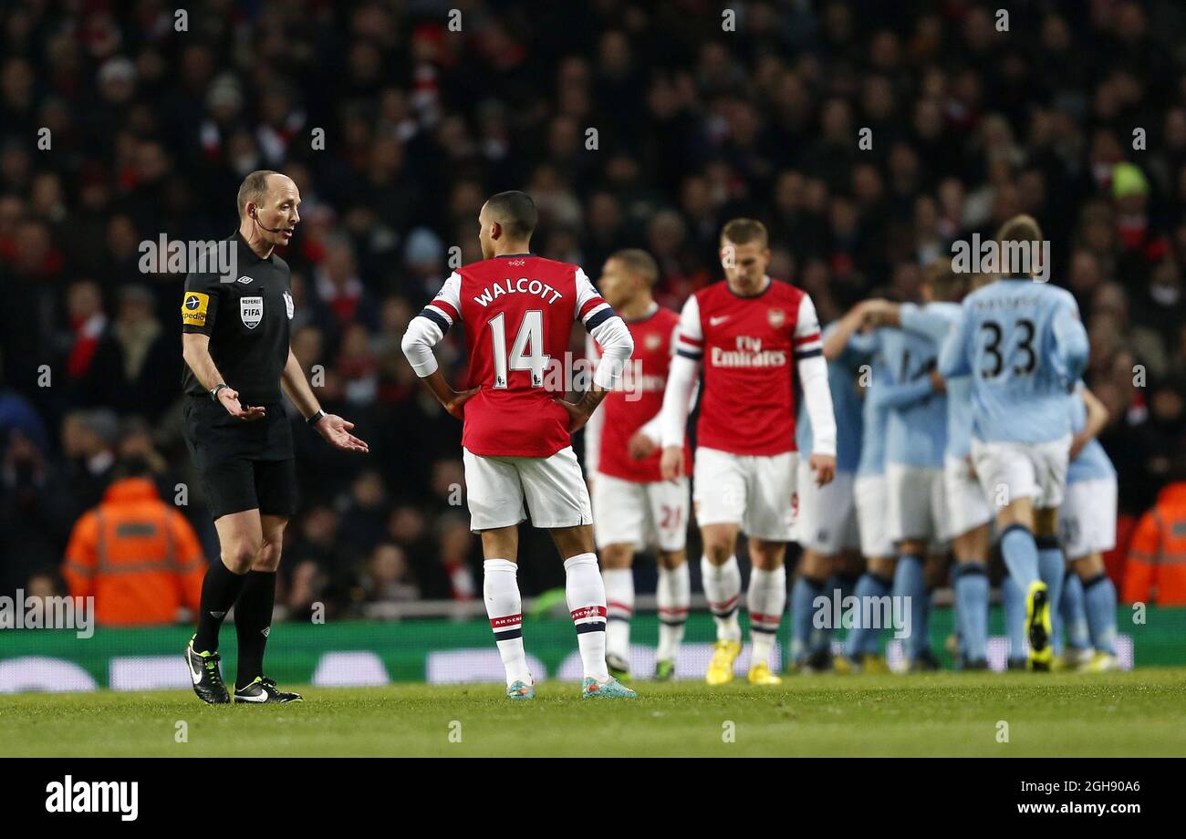 Arsenal's Theo Walcott complains to referee Mike Dean after Manchester City's opening goal during the Barclays Premier League between Arsenal and Manchester City at the Emirates Stadium in London on January 13, 2013. David Klein Stock Photo