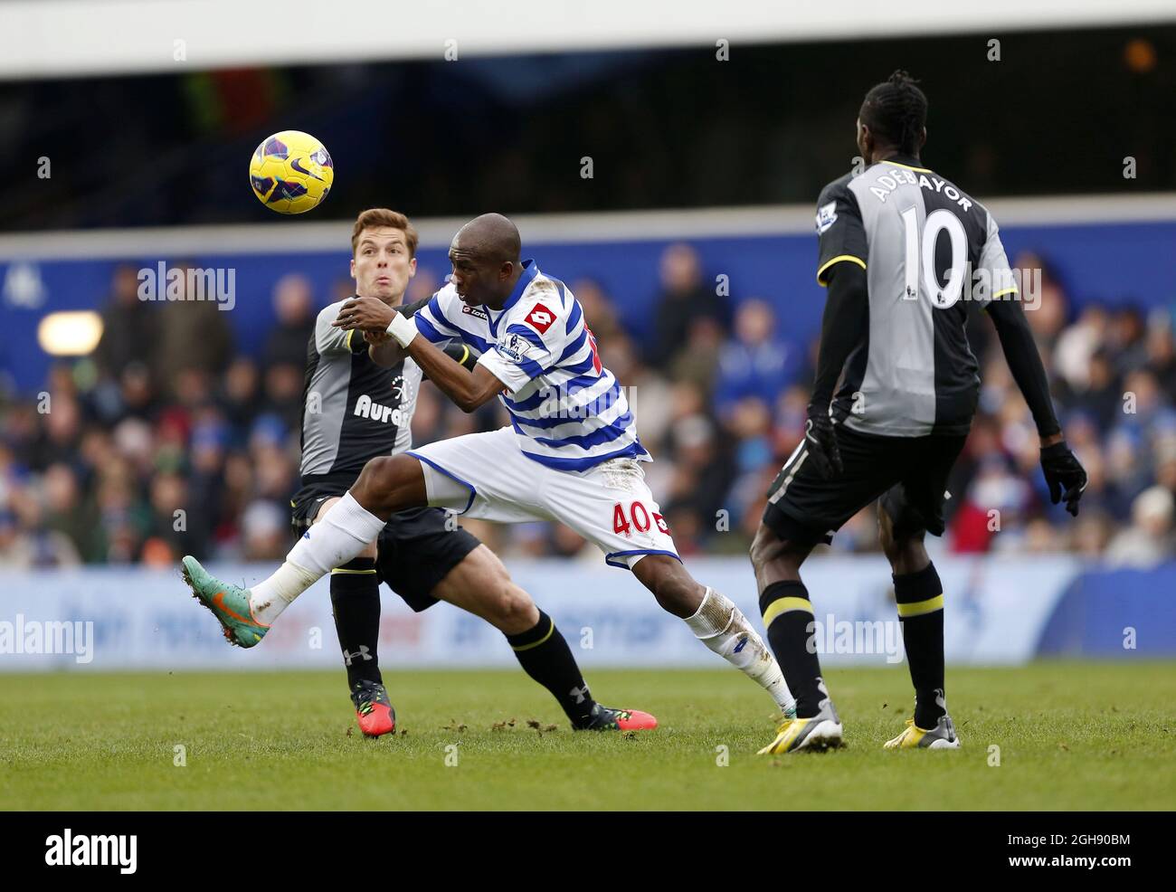 QPR's Stephane Mbia tussles with Tottenham's Scott Parker during the Barclays Premier League between Queens Park Rangers and Tottenham Hotspur at the Loftus Road in London on January 12, 2013. David Klein Stock Photo