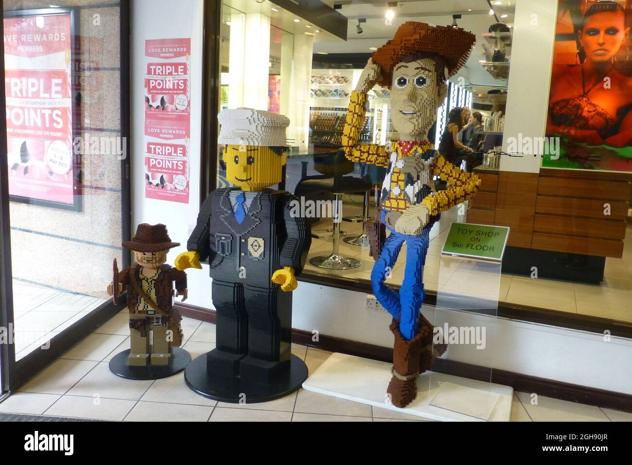 Woody in shop window Lego man cowboy shop front hat boots jeans floor ...