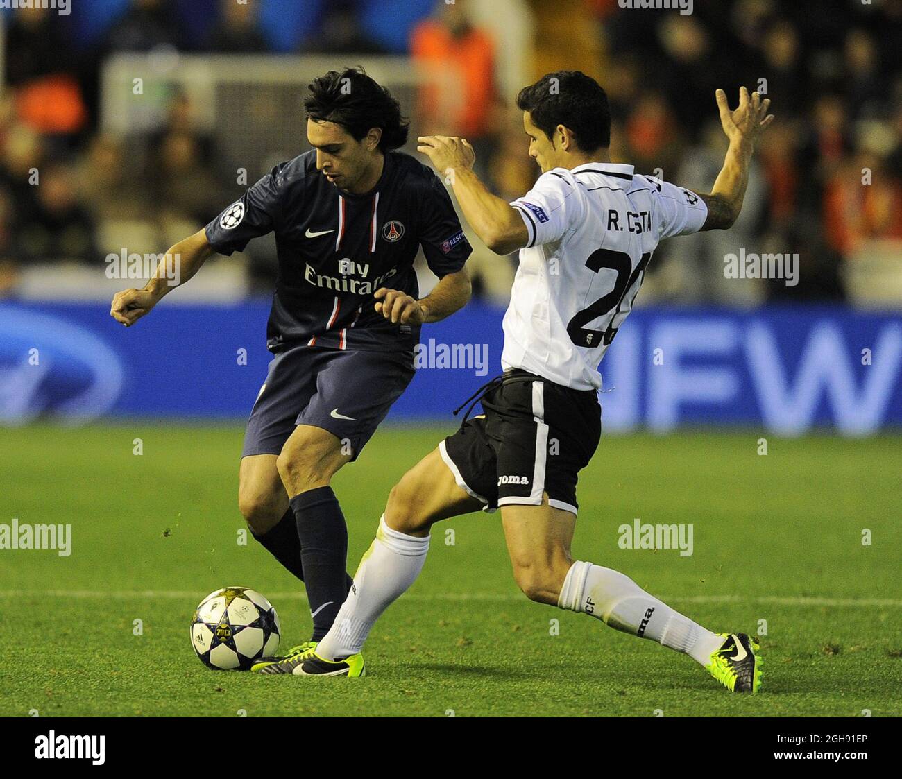 Javier Pastore of Paris Saint Germain tackled by Ricardo Costa of Valencia during the UEFA Champions League First Knockout Round of 16, first leg soccer match between Valencia and Paris Saint-Germain at the Mestalla Stadium in Valencia, Spain on February 12, 2013. CSMLandov Stock Photo