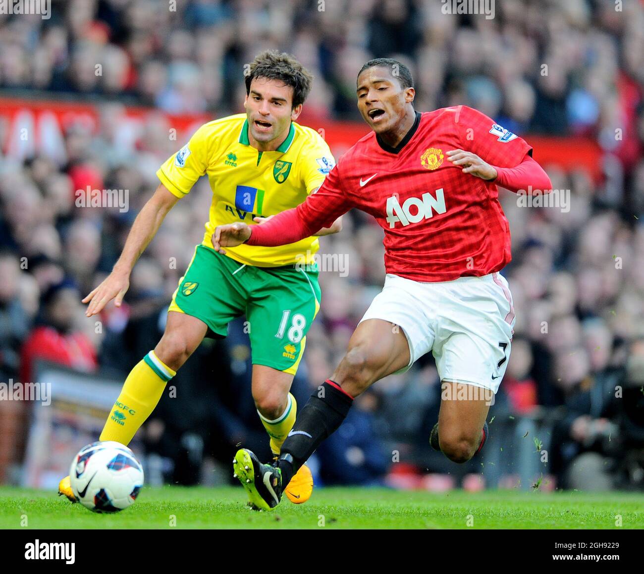 Javier Garrido of Norwich City brings down Luis Antonio Valencia of Manchester United during the Barclays Premier League match between Manchester United and Norwich City at the Old Trafford on March 02, 2013. Picture Simon Bellis Stock Photo