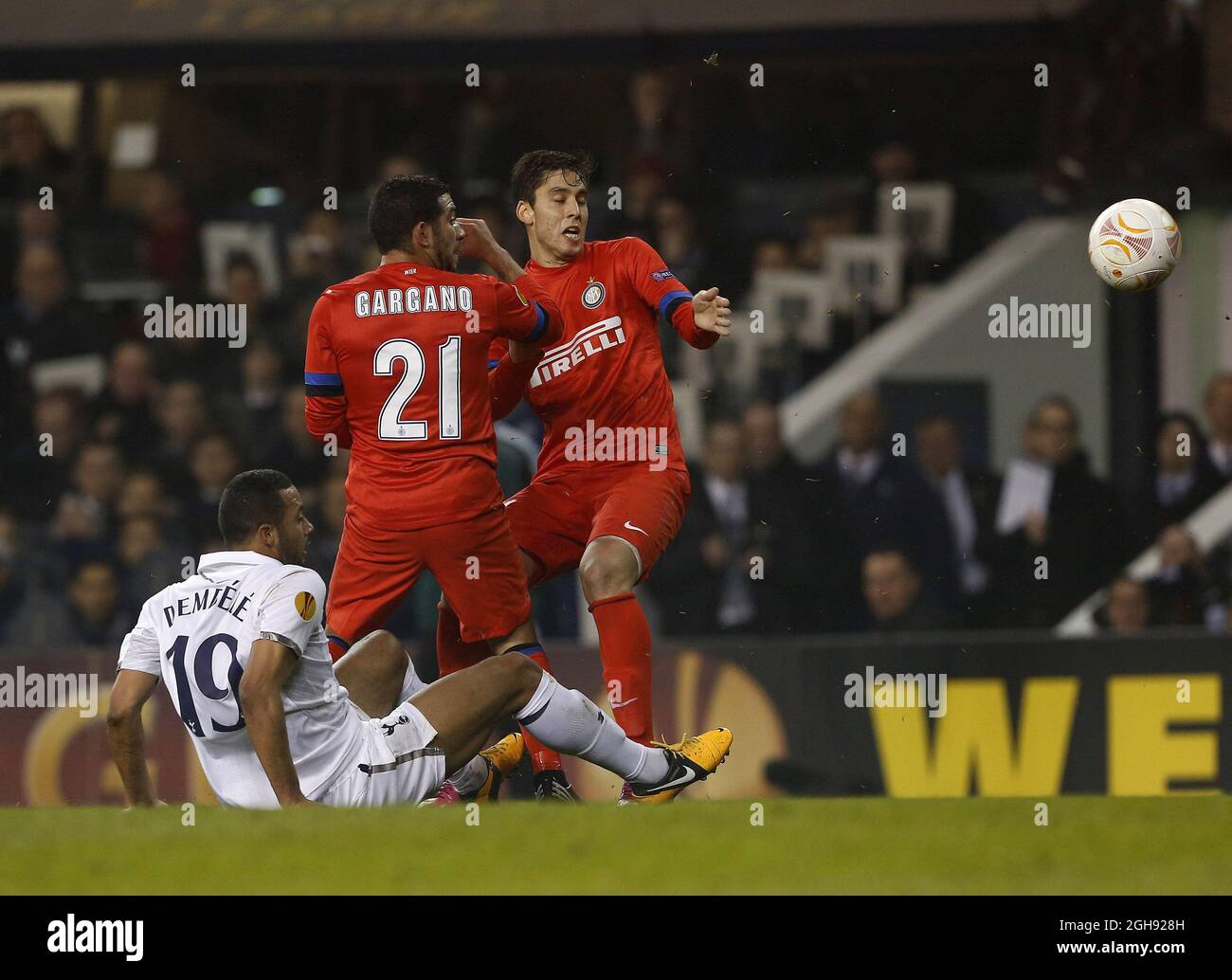 Tottenham's Moussa Dembele tussles with Inter's Walter Gargano and Andrea Ranocchia during the UEFA Europa League round of 16 first leg soccer match between Tottenham Hotspur and Inter Milan at White Hart Lane in London, United Kingdom on Thursday, March 7, 2013. Stock Photo