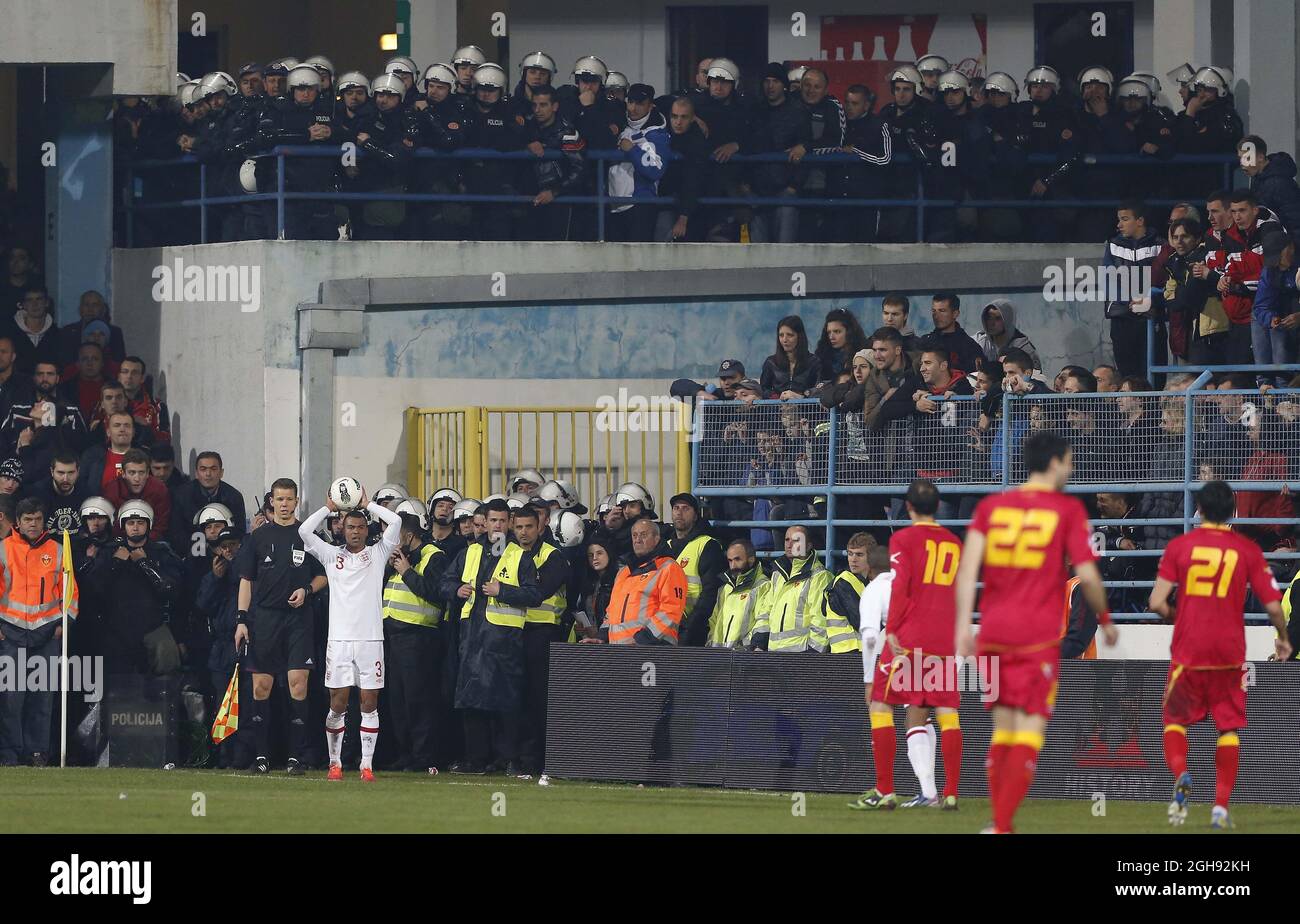 England's Ashley Cole finds himself surrounded by police during the 2014 World Cup Qualifier, Group H match between Montenegro and England at the City Stadium in Podgorica on March 26, 2013. Picture David Klein Stock Photo