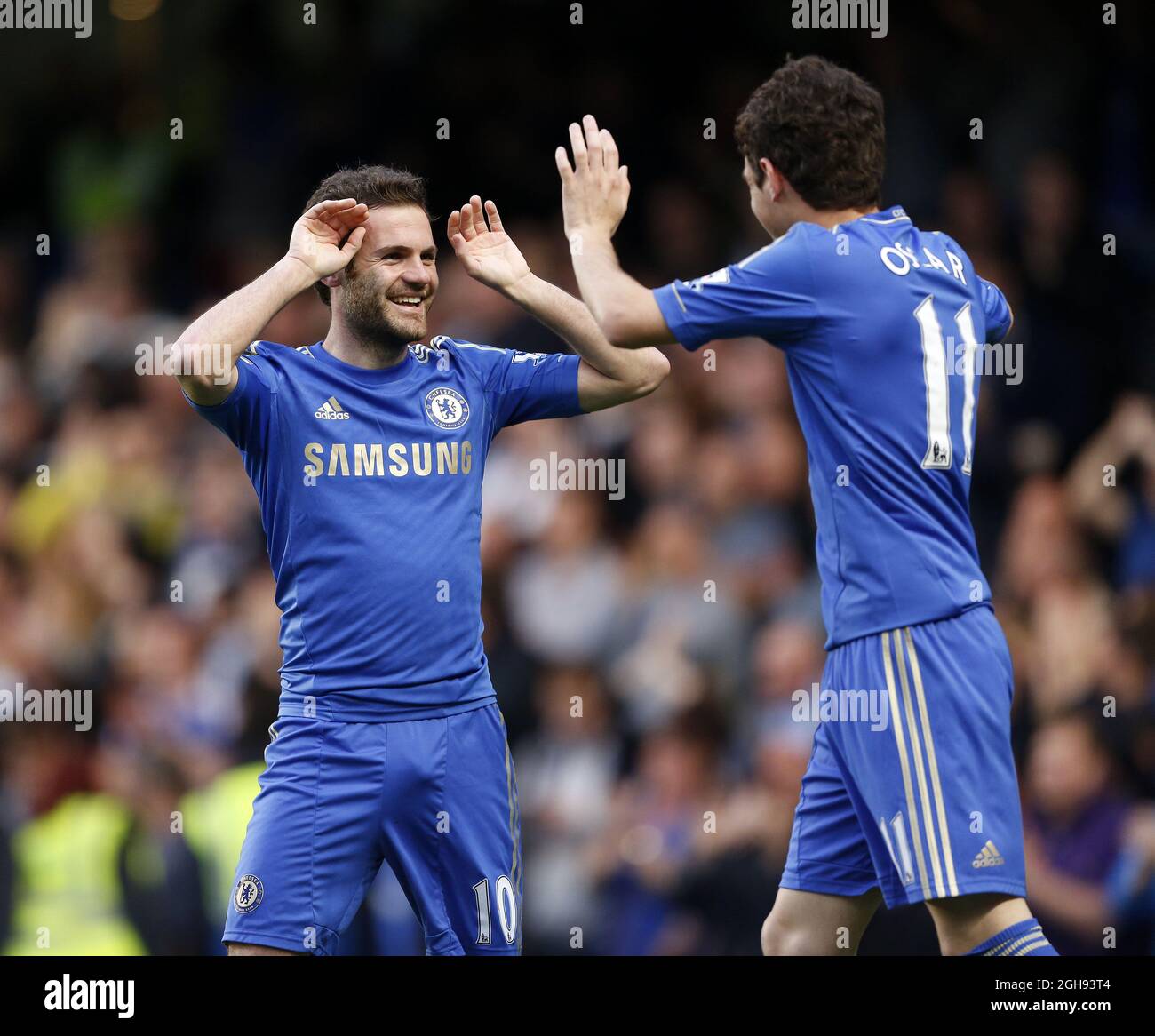 Chelsea's Oscar celebrates scoring his side's opening goal with Juan Mata during the Barclays Premier League match between Chelsea and Tottenham Hotspur at the Stamford Bridge in London on 8th May, 2013. Stock Photo