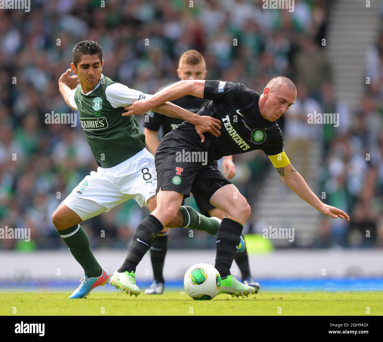 Celtic's Scott Brown holds off the challenge by Hibernian's Jorge Claros during the William Hill Scottish Cup Final between Hibernian and Celtic at the Hampden Park Stadium in Glasgow, Scotland on May 26, 2013. Picture Simon Bellis Stock Photo